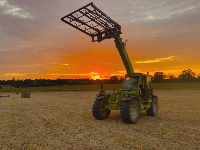 farm vehicle collecting hay